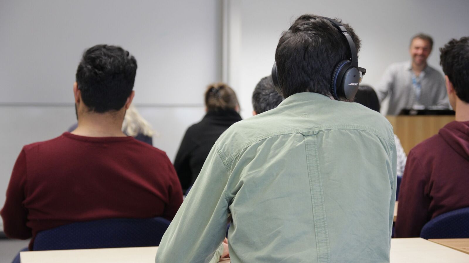 student listening with headphones to a lecture