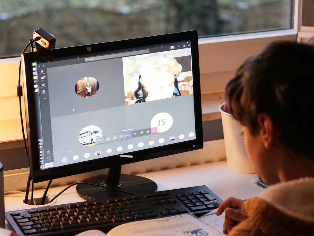 young person looking at computer for online learning